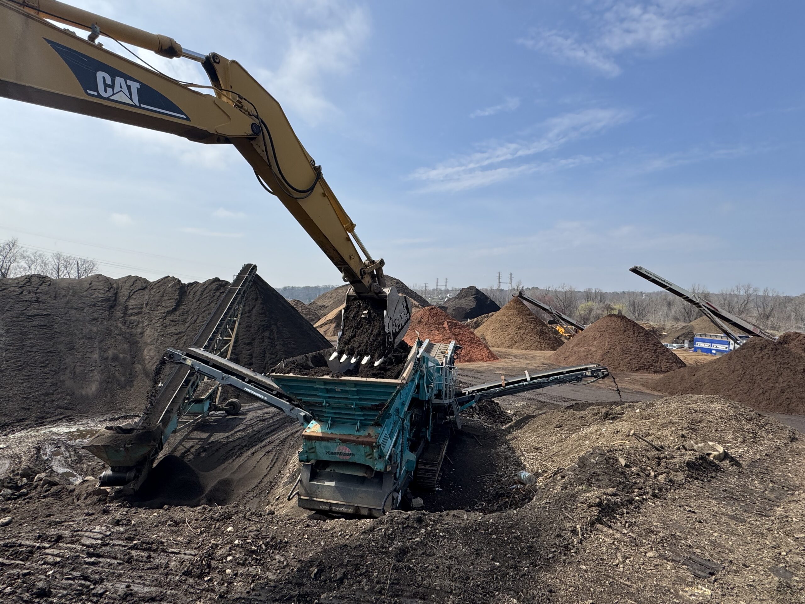 Topsoil screening operation with bulk stockpiles at Grillo Services 20-acre facility in Milford CT